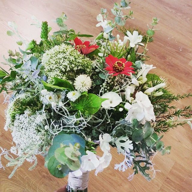 flower, freshness, high angle view, indoors, fragility, petal, table, wood - material, leaf, plant, vase, flower head, growth, bouquet, white color, beauty in nature, bunch of flowers, directly above, nature, wooden