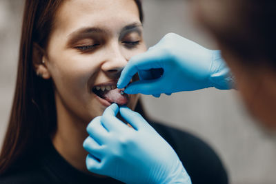 Close-up of woman holding dentures