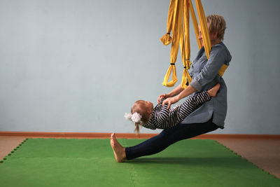 Portrait of young woman exercising in gym