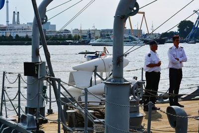 Rear view of people on boat sailing in river