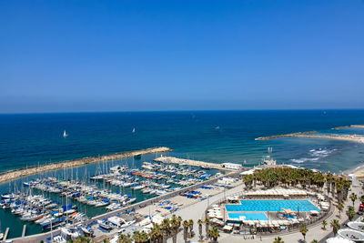 Aerial view of tel aviv skyline from top, yahts on the coastline.