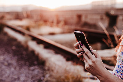 Midsection of man using mobile phone