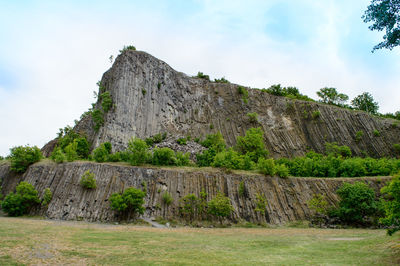 Low angle view of stone wall against sky