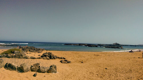 Scenic view of beach against clear sky