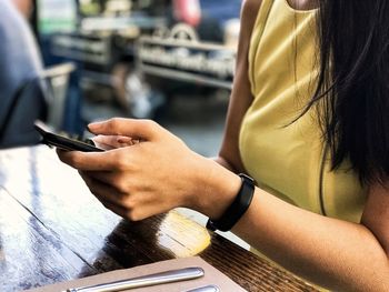 Midsection of woman using mobile phone