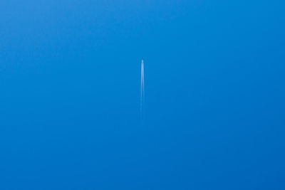Mid distance view of airplane flying against clear blue sky