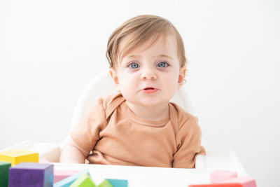 Cute boy with gray eyes against wall