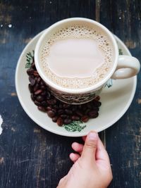 Midsection of coffee cup on table