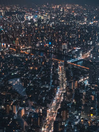 High angle view of illuminated city buildings at night