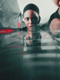 Close-up portrait of man with reflection against gray background