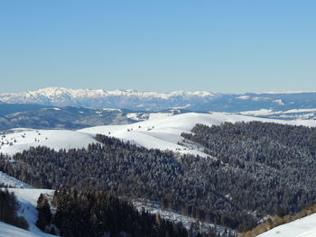 Scenic view of snowcapped mountains against clear sky