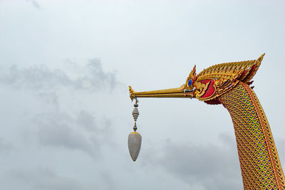 Low angle view of statue against sky