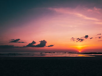 Scenic view of sea against romantic sky at sunset