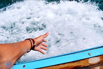 Low section of man on boat sailing in sea