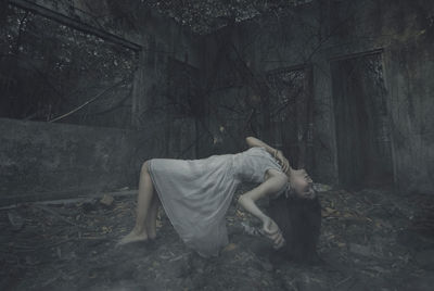 Digital composite image of woman lying down in forest