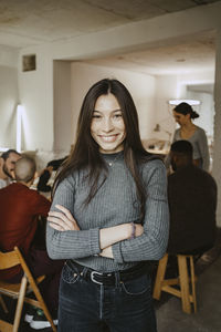 Portrait of smiling female hacker in startup company