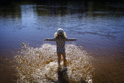 Full length of toddler standing against sea