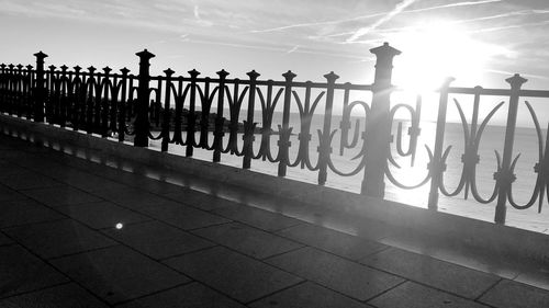 Silhouette railing against sky