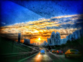 Cars on road at sunset