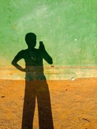 Woman standing on yellow shadow