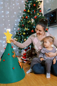 Portrait of cute girl decorating christmas tree