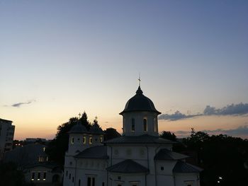 View of buildings against sky at sunset