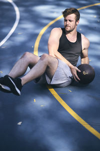 Young man exercising on basketball court