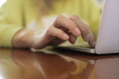 Midsection of woman using mobile phone