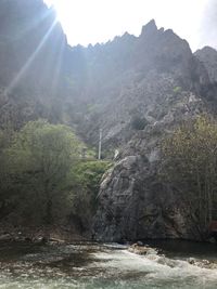 Scenic view of waterfall against sky