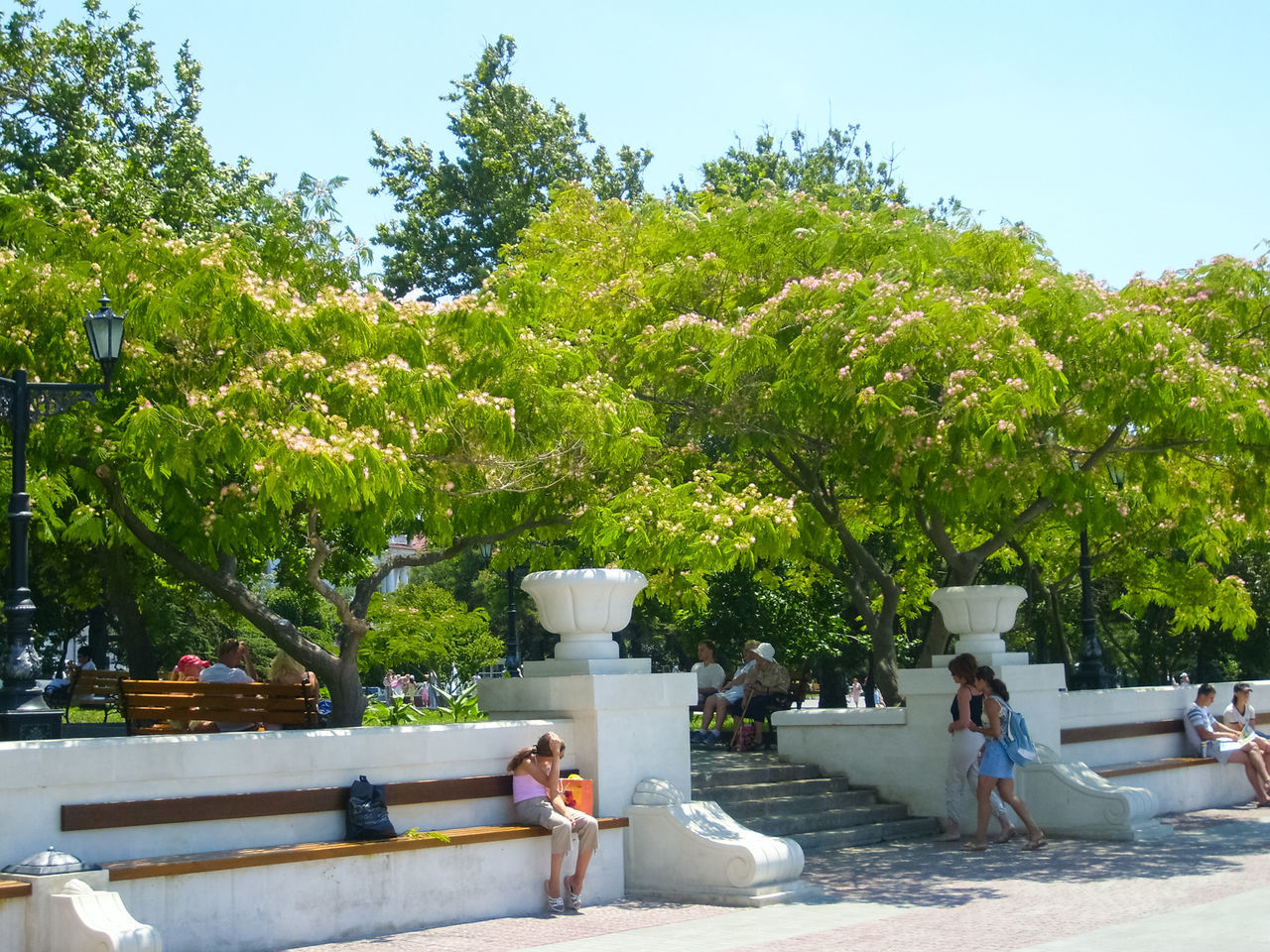 PEOPLE SITTING BY SWIMMING POOL