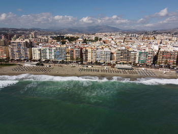 Scenic view of sea and buildings against sky