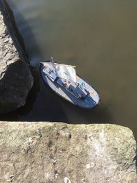 High angle view of toy boat by rock in lake