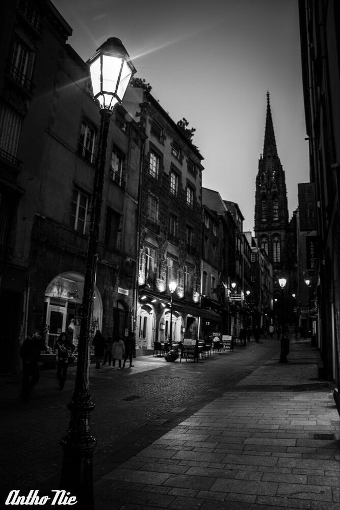 VIEW OF ILLUMINATED CITY STREET AT NIGHT