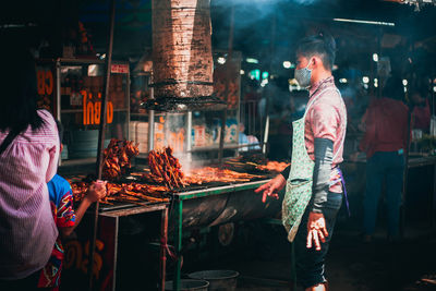 People standing at market stall