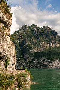 Scenic view of sea and mountains against sky