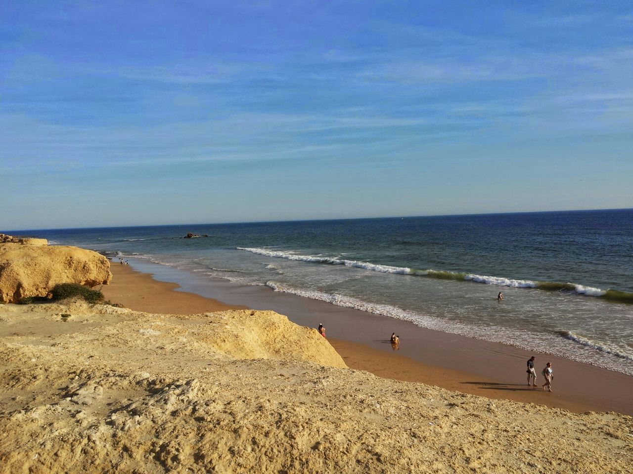 sea, beach, horizon over water, water, shore, sand, sky, scenics, tranquil scene, tranquility, beauty in nature, nature, coastline, idyllic, incidental people, wave, cloud - sky, rock - object, blue, outdoors