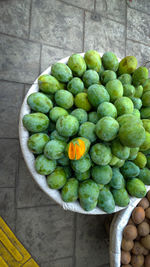 High angle view of fruits in container on floor