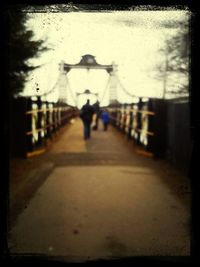 Woman walking on footbridge