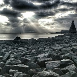 Scenic view of sea against cloudy sky