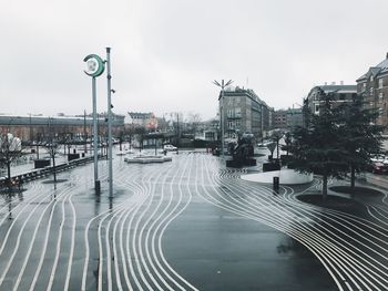 Road by city against sky