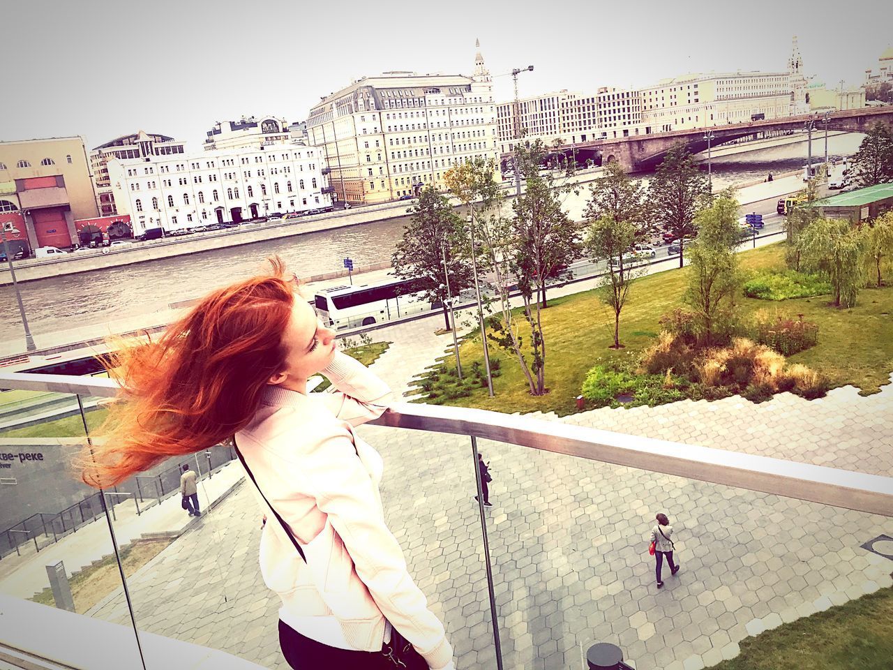 WOMAN STANDING IN CITY AGAINST SKY