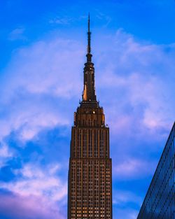 Low angle view of building against cloudy sky