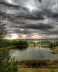 Scenic view of lake against cloudy sky