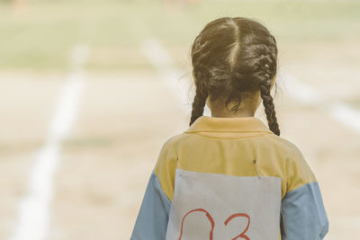 Rear view of girl standing outdoors