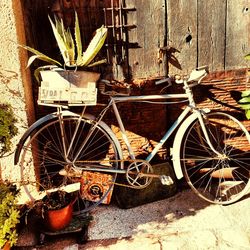 Bicycle parked by abandoned wall