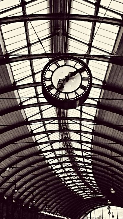 indoors, architecture, ceiling, built structure, low angle view, skylight, glass - material, pattern, directly below, architectural feature, modern, design, full frame, backgrounds, clock, time, geometric shape, railroad station, window, no people