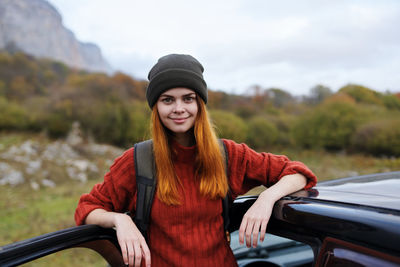 Portrait of beautiful young woman in car