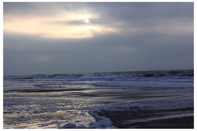 Scenic view of sea against cloudy sky