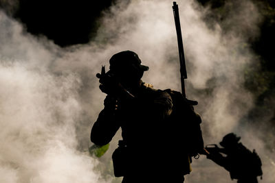 Low angle view of man standing against sky