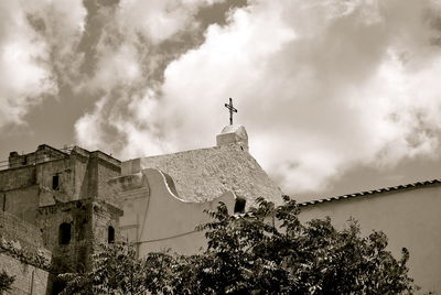 Low angle view of church against cloudy sky